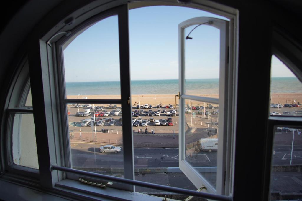 a view of the beach from a window at Two Bed Flat Sea view Old town Hastings in Hastings