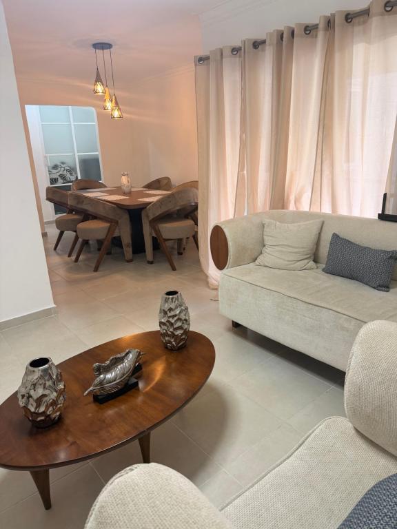 a living room with a couch and a table at The Palace in San Isidro