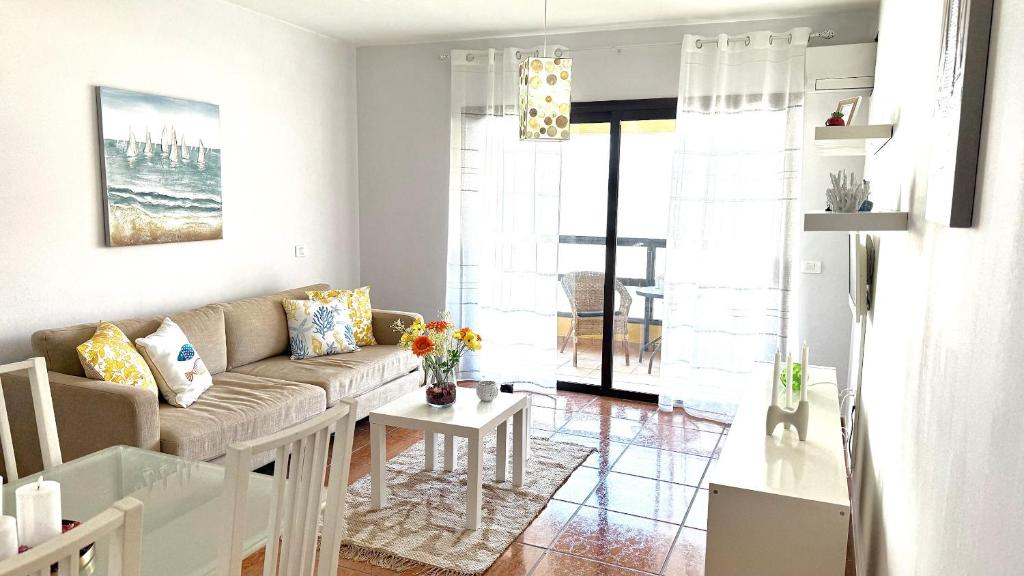 a living room with a couch and a table at 525 Aguamarina in San Miguel de Abona