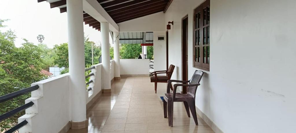 a hallway of a house with chairs and a porch at White House in Puttalam