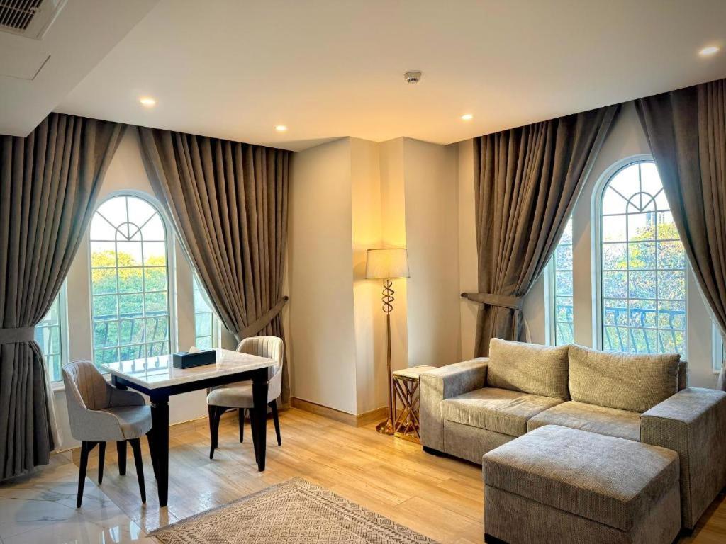 a living room with a couch and a table at Chirani Signature Hotel in Islamabad