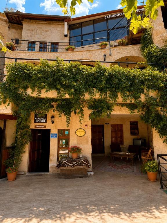a building with ivy growing on the side of it at Cappadocia Cave House in Ürgüp