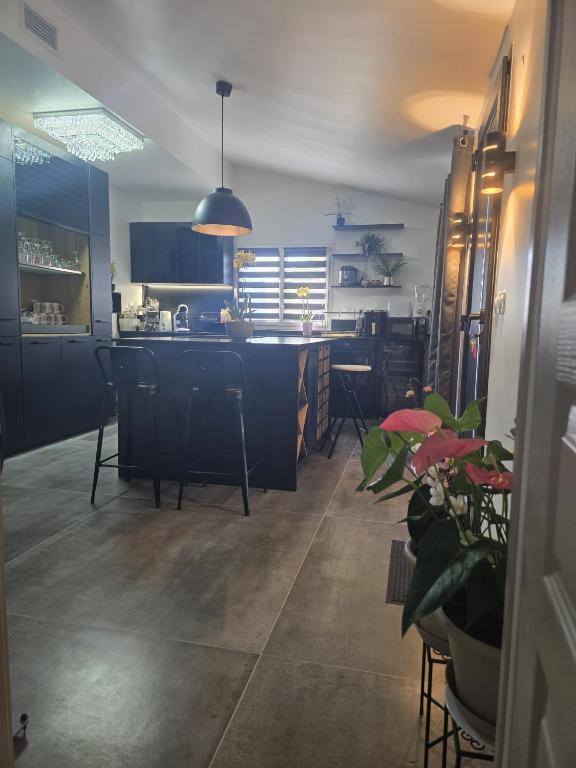 a kitchen with a island with chairs and a table at L'instant cosy climatisé 2 in Sisteron