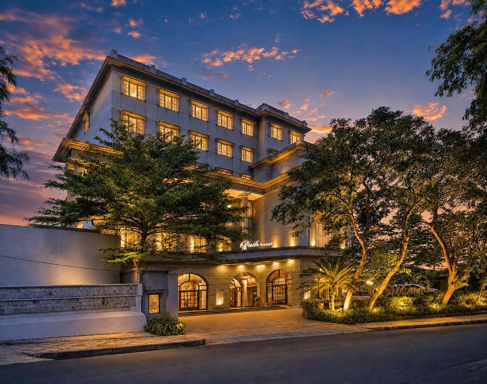 a large building with its lights on at night at Onih Hotel in Bogor