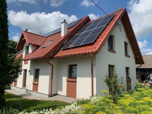 a house with solar panels on the roof at Kubanka dom pokoje apartamenty in Płocice