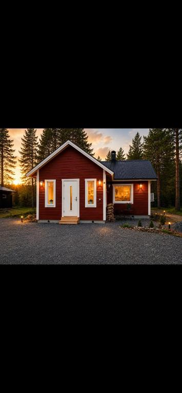 a small red house with a white door at Little Home in Kolari