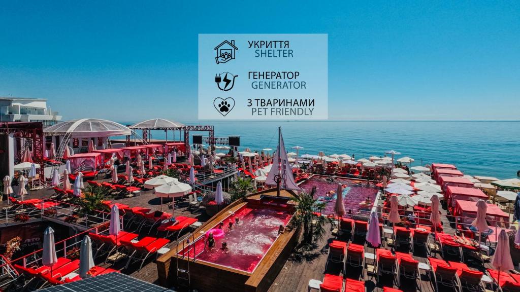 a cruise ship with a pool and tables and chairs at Arkadia Beach Hotel in Odesa