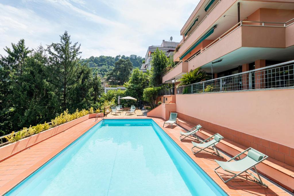 a swimming pool on the balcony of a building at Easylife - Como Villa Sofia Apartments in Como