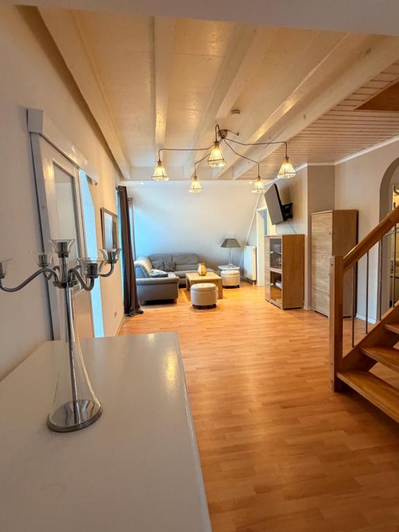 a living room with a couch and a table at Generations Holiday City Lofts am Neumarkt Kölner Straße 23a in Attendorn