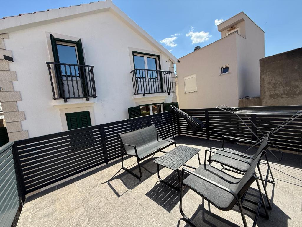 a patio with chairs and a table on a balcony at House Marin - by the beach in Igrane