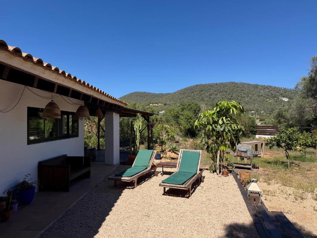 two chaise lounges on a patio next to a house at Can Jondalet in Sant Josep