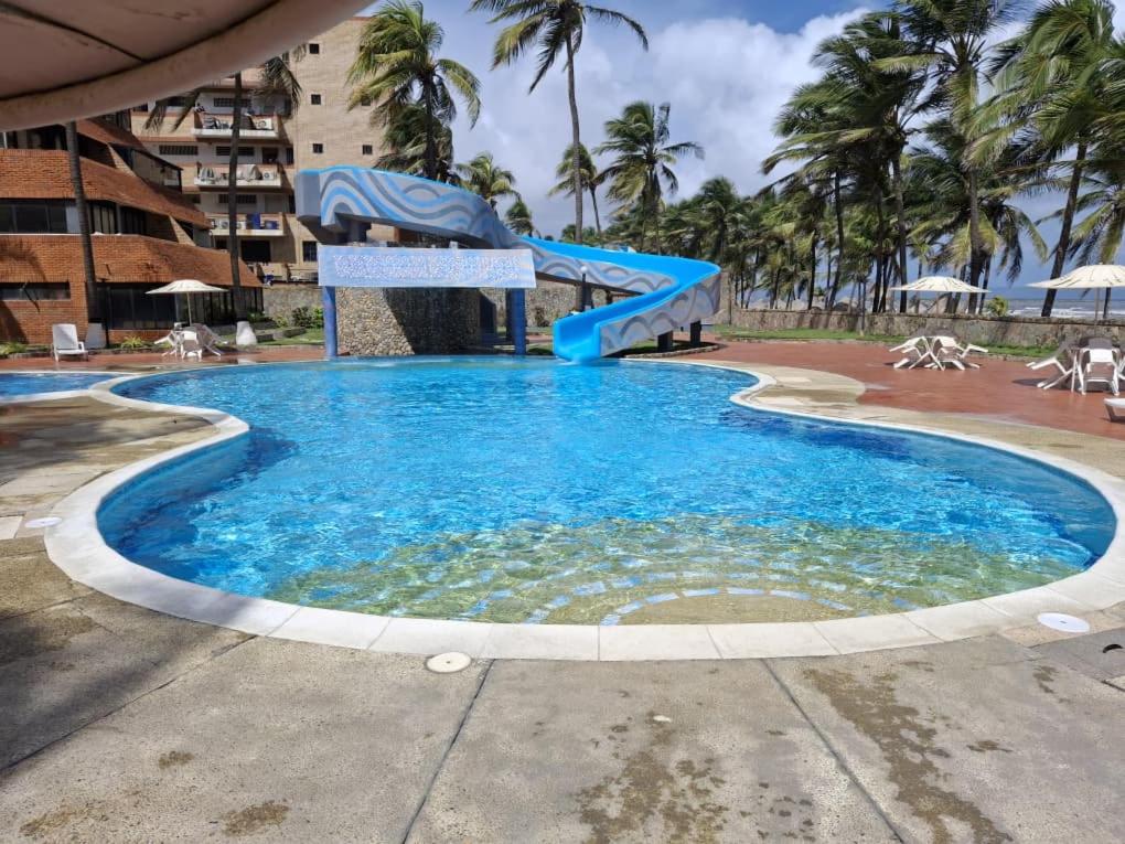 a large swimming pool with a water slide at Nautilus suites in Tucacas