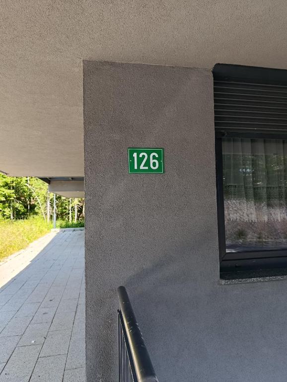 a green sign on the side of a building at Virgin Forest D&A in Gornja Presjenica