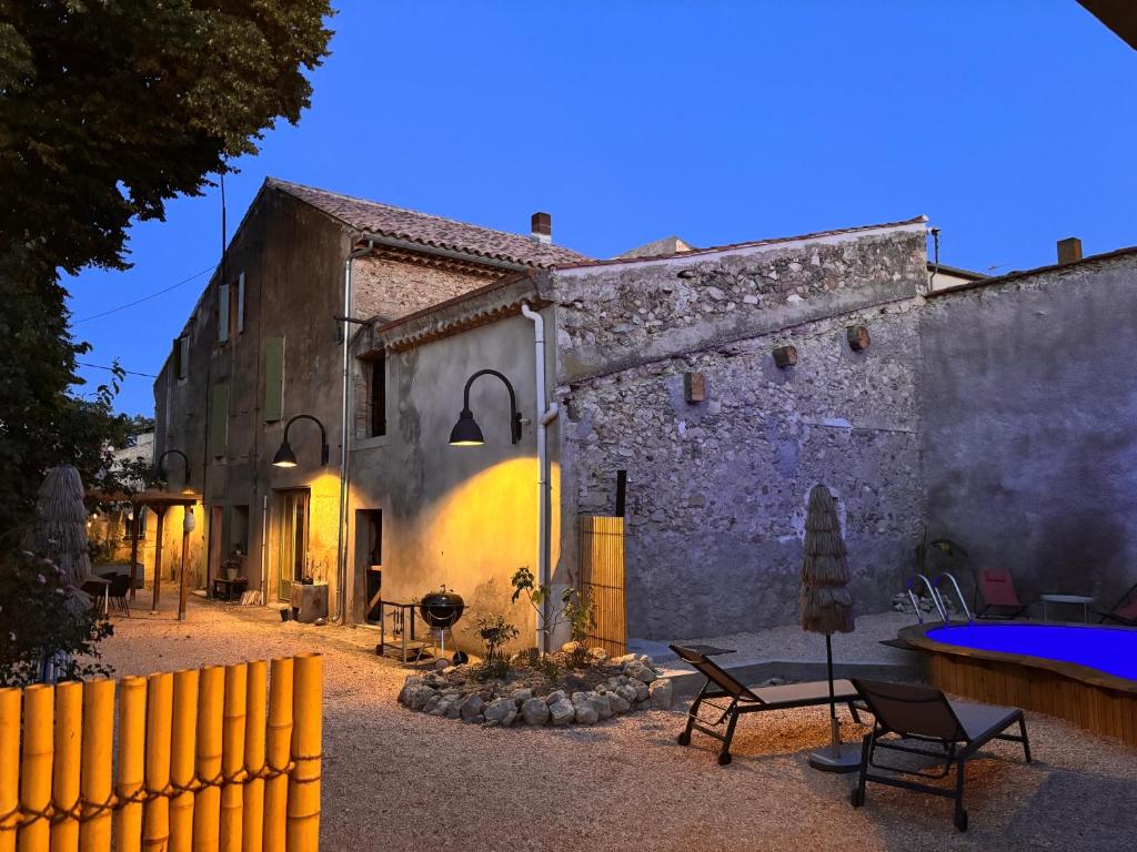 a building with a fence in front of it at Le Son des Violons in Sallèles-dʼAude