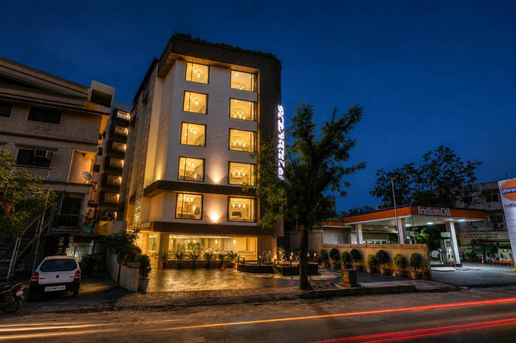 a tall building with lights on in a city at Scenaria Hotel - Navrangpura, Ahmedabad in Ahmedabad