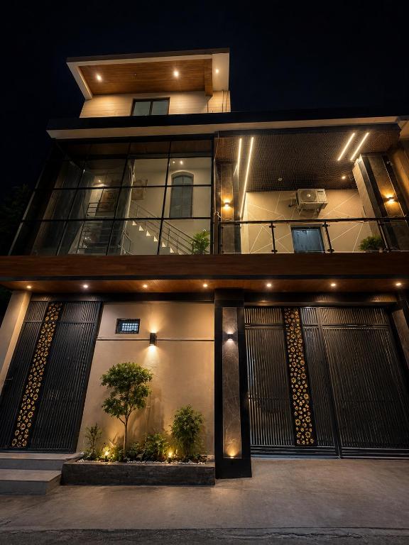 a building with a lit up facade at night at Hotel New Vedas Villa 15 mints From Ram Temple in Ayodhya