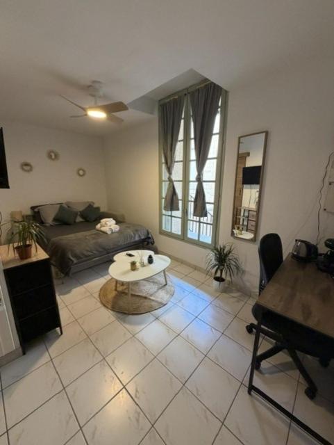 a living room with a couch and a table at Saint-Pierre Studio in Avignon