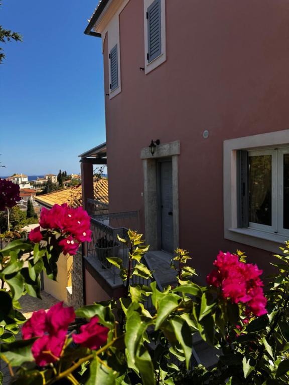 a house with pink flowers in front of it at Flowerhouse in Porto Heli
