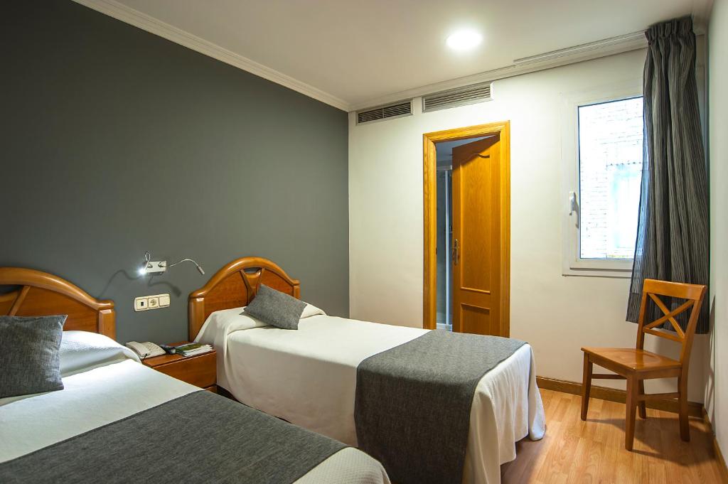 Postel nebo postele na pokoji v ubytování Iraipe Izaga Hostal