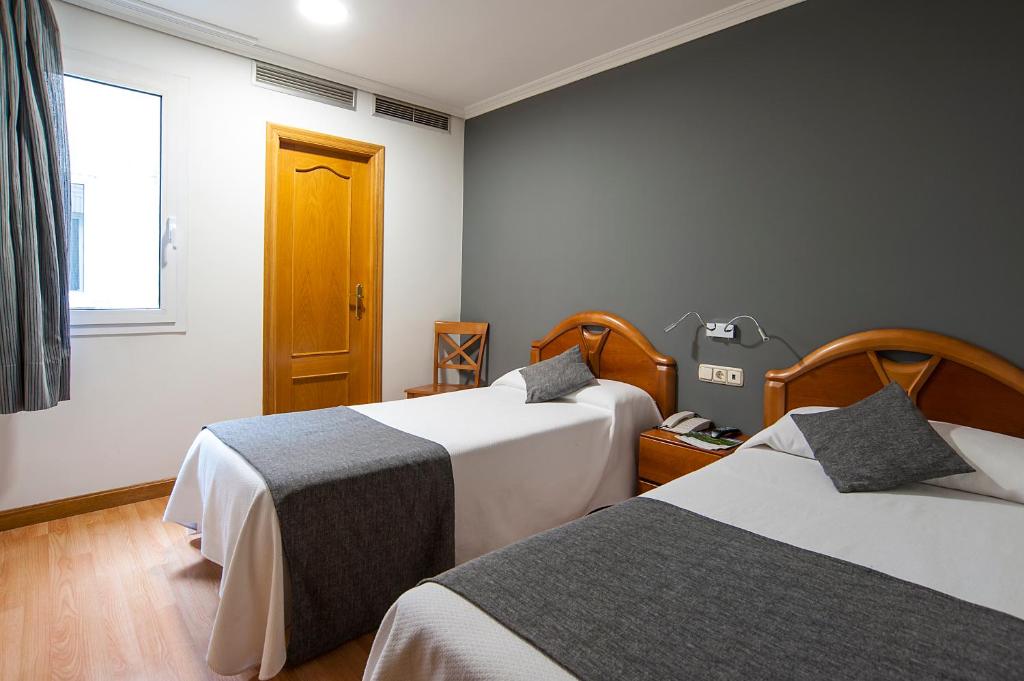 Postel nebo postele na pokoji v ubytování Iraipe Izaga Hostal