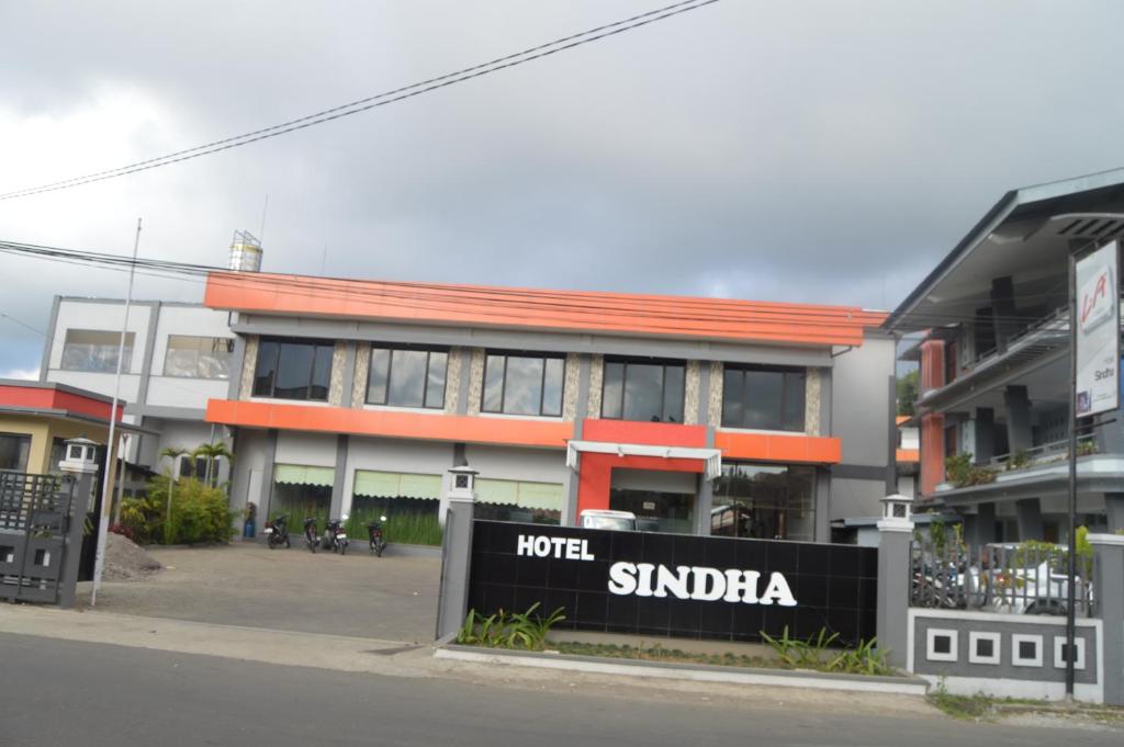 a building with a sign in front of it at Hotel Sindha in Ruteng