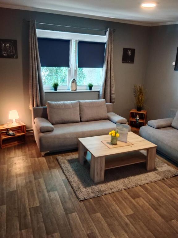 a living room with a couch and a coffee table at FjordHome in Flensburg