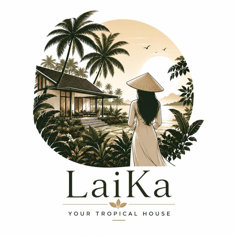 a woman in a hat standing in front of a tropical house at LaiKa in Phú Quốc