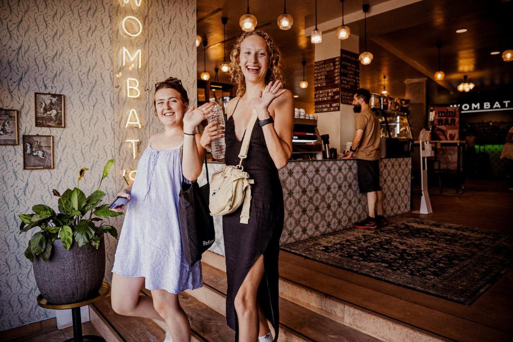 two women standing next to each other in a store at Wombat's City Hostel Vienna Naschmarkt in Vienna