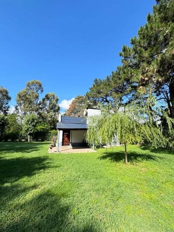 a house in the middle of a green field at Quinta El Arrayan in Tandil