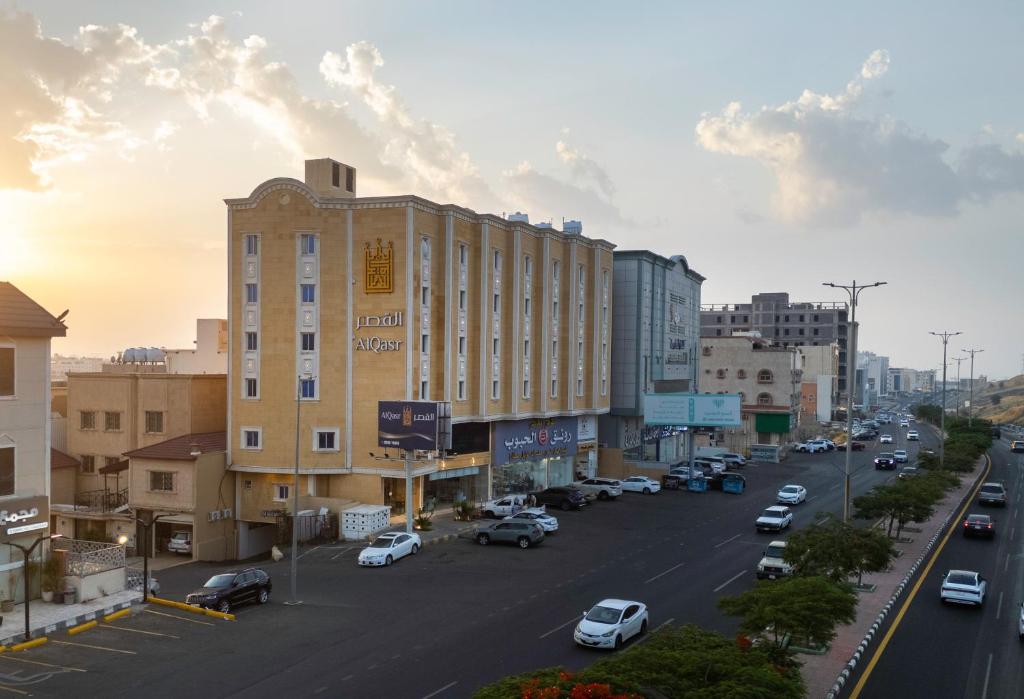 a city street with a building and cars parked at AlQasr - Almansak in Abha