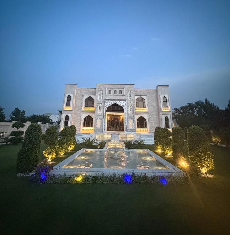 an exterior view of a building with a fountain at Hamzas production in Islamabad