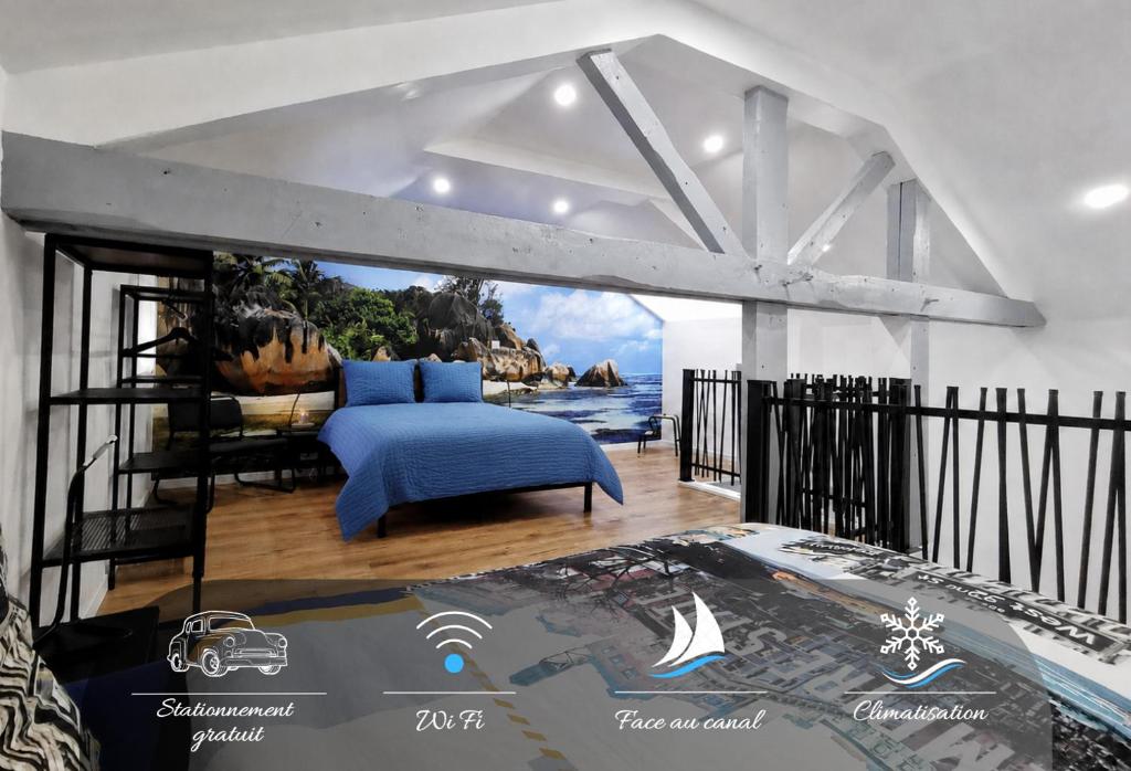 a bedroom with a blue bed and a view of the ocean at Le temps d'une pause -4- in Cepoy