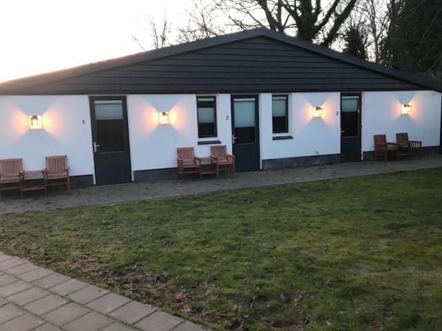 a white building with benches and lights on it at B&B An de N35 in Zwolle