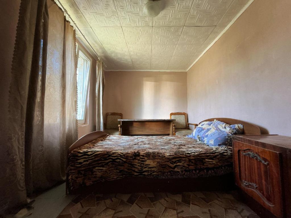 a bedroom with a bed and a window at BurshtynSV in Svityazʼ
