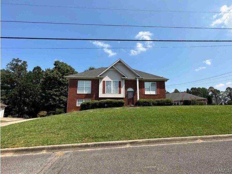 a house on the side of a street with a yard at Birmingham Haven New Deck King Bed No Cleaning Fee in Birmingham