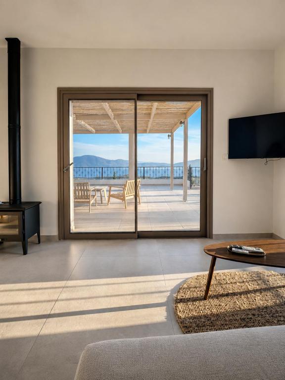 a living room with a view of the ocean at Trigono Suites - Primavera 