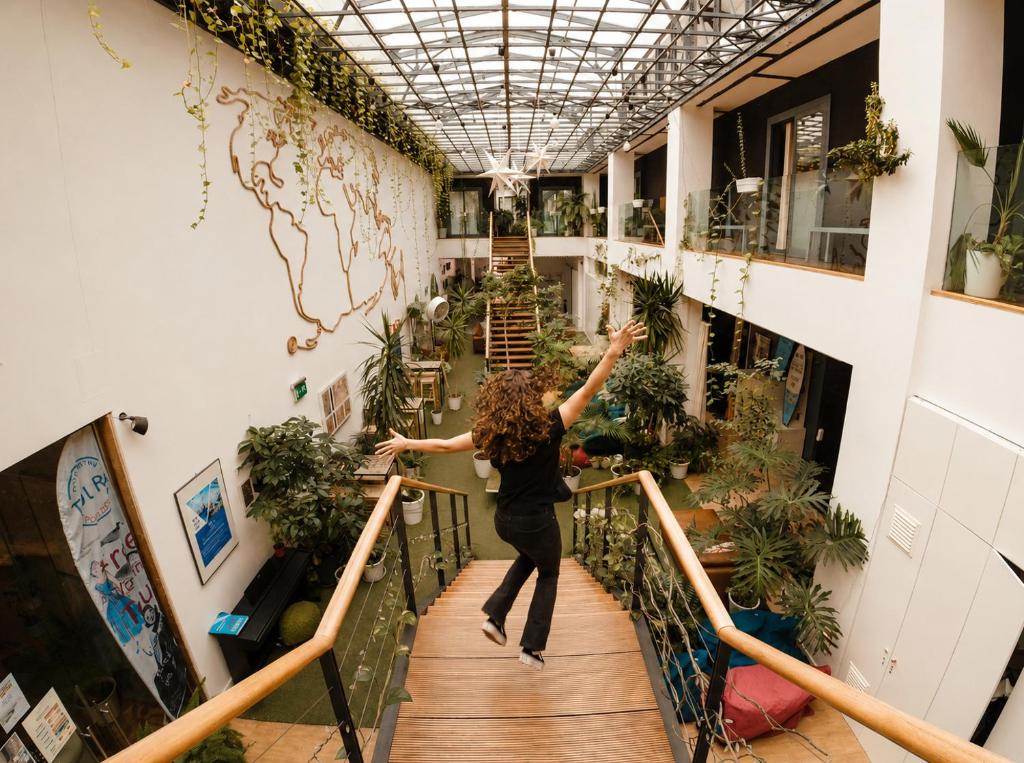 a woman is walking down a stairs in a greenhouse at Lisbon Destination in Lisbon
