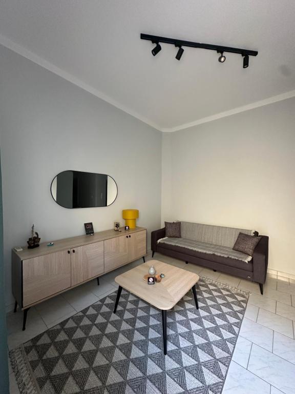 a living room with a couch and a table at Anassa Homes Leros in Agia Marina