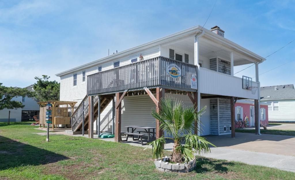 a house with a balcony on top of it at Turtle-ly Beachin' - KDH MP 6, Ocean View, Beach 165 Yds, Sound Access, Year Round Flex Stays in Kill Devil Hills