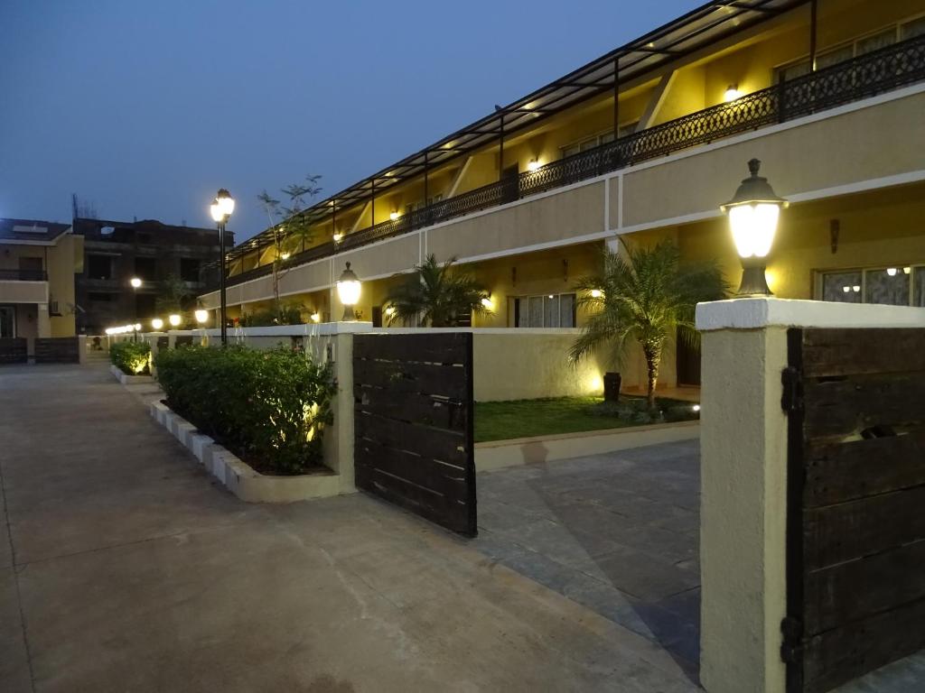 a building with a courtyard at night with lights at Misty Meadows, Lonavala in Lonavala