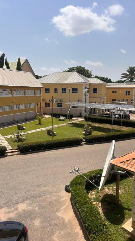 a building with a school with a white object on the grass at NBTE Hotels in Kaduna