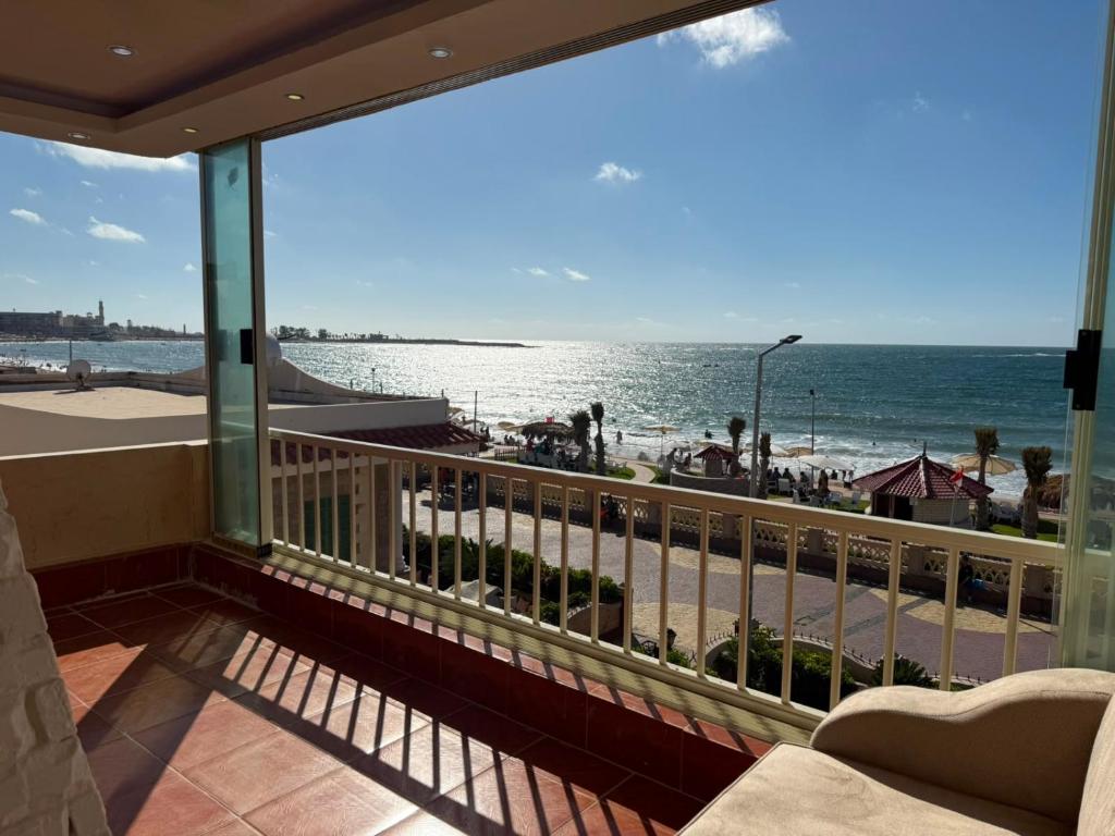 a balcony with a view of the beach and the ocean at Direct Beachfront - Sea View 2 bed rooms in Jazīrat al Maskhūţah
