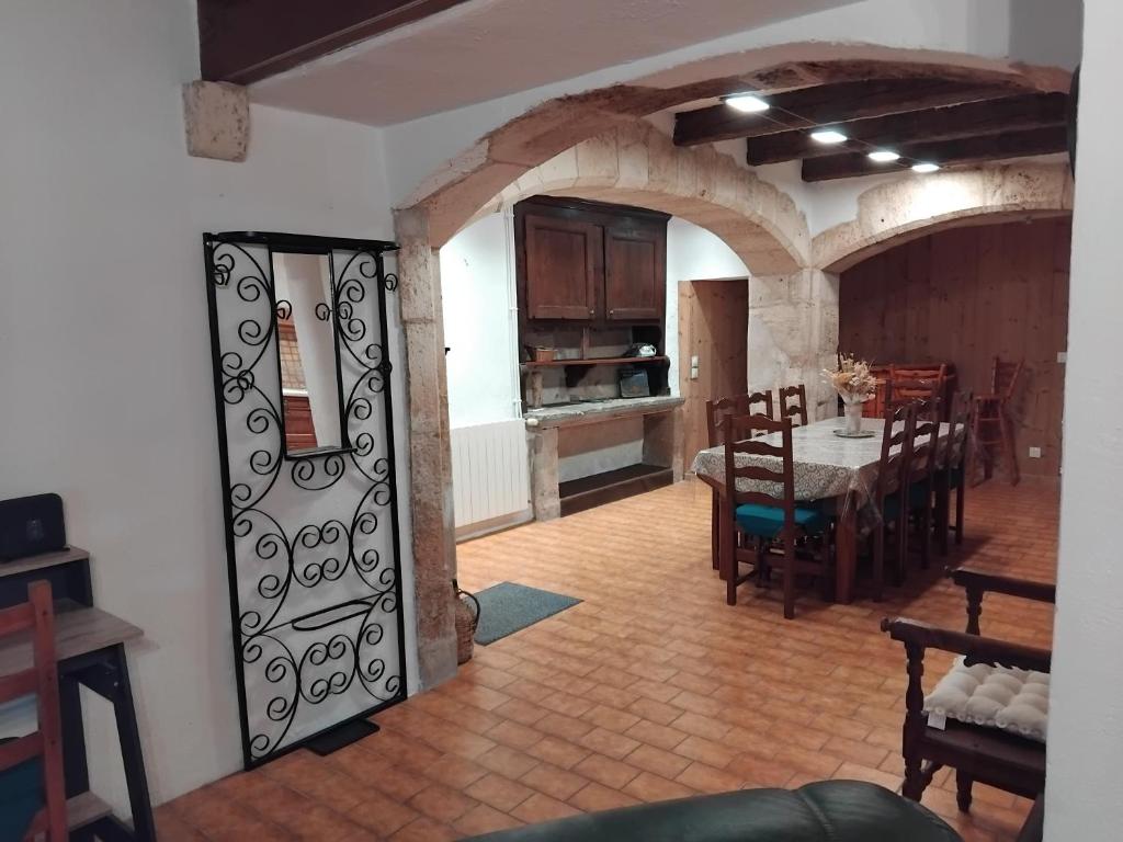 a living room with a table and a dining room at gite La Tour Au Comté in Charency