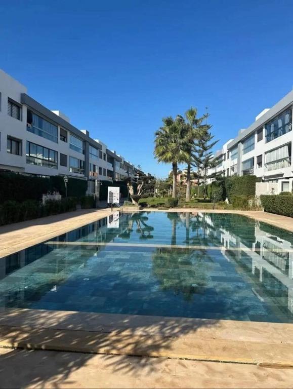 a swimming pool in front of a building at Comfort and luxury with pool in Tamaris