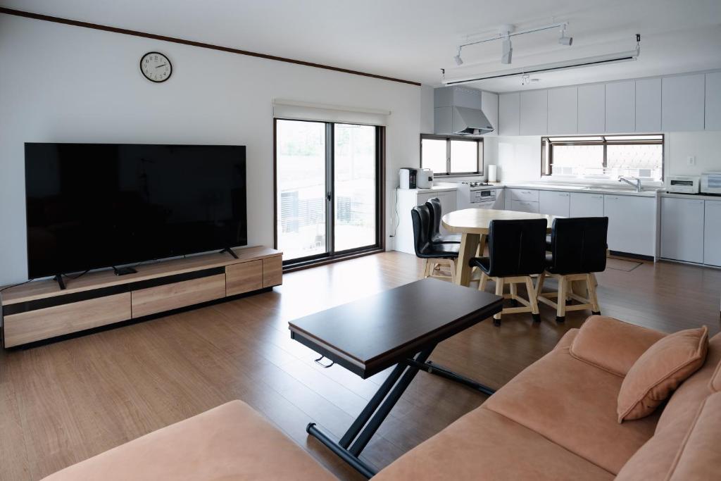 a living room with a large flat screen tv at Kaga Travel - Hakusandai, Whole building for rent in Kaga