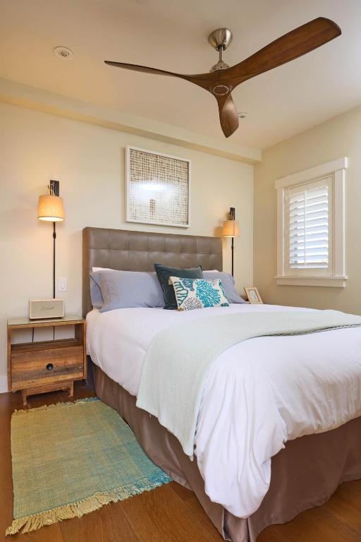 a bedroom with a large bed with a ceiling fan at Playa One Bedroom (251) in Carpinteria