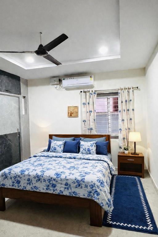 a bedroom with a bed and a ceiling fan at Gayathri Residency premium 2bhk in Hyderabad