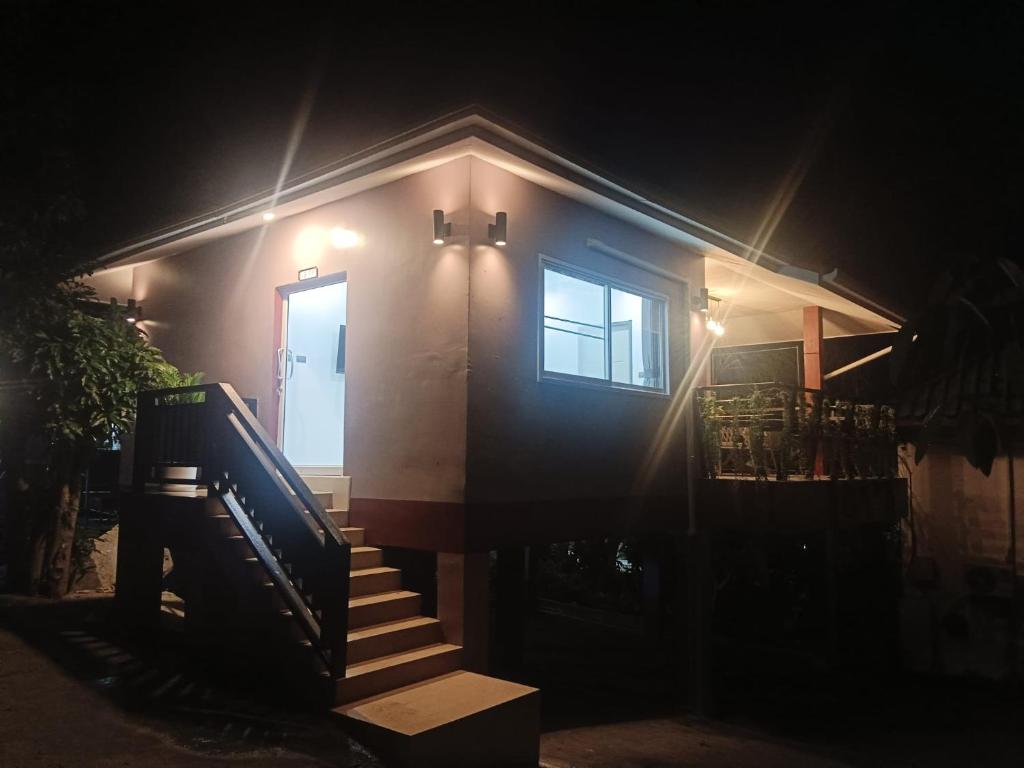 a house with a staircase leading to a door at night at Elevated Bungalow House 3-11 in Nathon Bay
