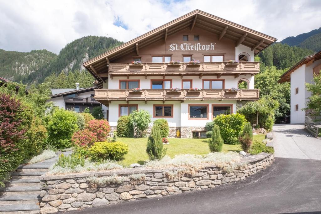 a building in the mountains with a stone wall at Haus St. Christoph in Mayrhofen