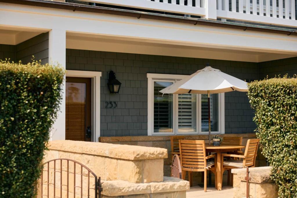 a patio with a table and an umbrella at Playa One Bedroom (253) in Carpinteria